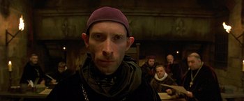 Movie still from “The Messenger: The Story of Joan of Arc” (1999), directed by Luc Besson – A person wearing a hat; Close Up shot, Low angle
