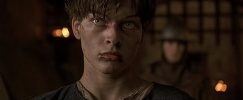Movie still from “The Messenger: The Story of Joan of Arc” (1999), directed by Luc Besson – A person with a bruised face; Close Up shot, Low angle