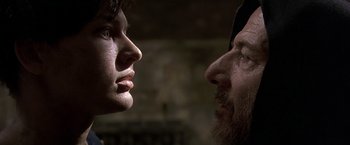 Movie still from “The Messenger: The Story of Joan of Arc” (1999), directed by Luc Besson – A man and a woman face to face in the dark; Close Up shot, Over the shoulder angle