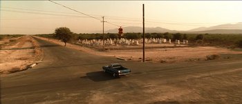 Movie still from “The Mexican” (2001), directed by Gore Verbinski – A car is parked on the side of the road; Extreme Wide shot, High angle