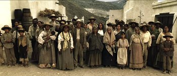 Movie still from “The Mexican” (2001), directed by Gore Verbinski – A group of people standing next to each other on a street; Wide shot, High angle