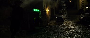 Movie still from “The Mexican” (2001), directed by Gore Verbinski – A car parked on the side of the road at night; Extreme Wide shot, High angle