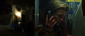 Movie still from “The Mexican” (2001), directed by Gore Verbinski – A woman talking on a phone through a glass window; Close Up shot, High angle