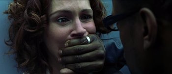 Movie still from “The Mexican” (2001), directed by Gore Verbinski – A woman with her hands over her mouth; Extreme Close Up shot, Overhead angle