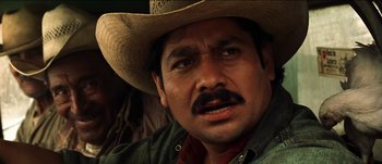 Movie still from “The Mexican” (2001), directed by Gore Verbinski – A person wearing a cowboy hat; Close Up shot, Over the shoulder angle