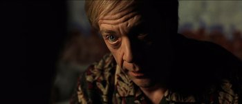 Movie still from “The Mexican” (2001), directed by Gore Verbinski – A person wearing a floral shirt; Close Up shot, Low angle