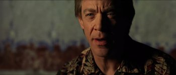 Movie still from “The Mexican” (2001), directed by Gore Verbinski – A man's face in the dark; Close Up shot, Over the shoulder angle