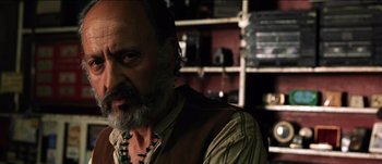 Movie still from “The Mexican” (2001), directed by Gore Verbinski – A man with a long beard and a mustache; Close Up shot, Low angle