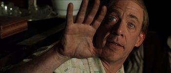 Movie still from “The Mexican” (2001), directed by Gore Verbinski – An older man holding his hand up in the air; Close Up shot, Low angle