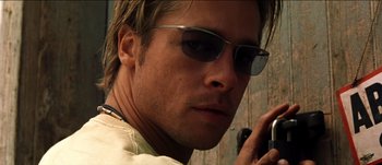 Movie still from “The Mexican” (2001), directed by Gore Verbinski – A person wearing sunglasses and holding a cell phone; Close Up shot, Low angle