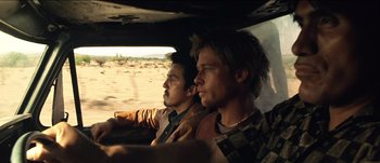 Movie still from “The Mexican” (2001), directed by Gore Verbinski – Two men are driving in a car in the desert; Medium shot, Over the shoulder angle