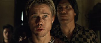 Movie still from “The Mexican” (2001), directed by Gore Verbinski – A man with blue eyes is looking at the camera with another man; Close Up shot, Low angle