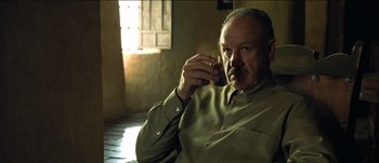 Movie still from “The Mexican” (2001), directed by Gore Verbinski – An older man sitting in front of an open window; Close Up shot, Low angle