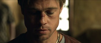 Movie still from “The Mexican” (2001), directed by Gore Verbinski – A person with a bandage on his face; Close Up shot, Low angle