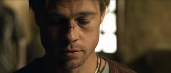 Movie still from “The Mexican” (2001), directed by Gore Verbinski – A person with a bandage on his face; Close Up shot, Low angle