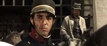 Movie still from “The Mexican” (2001), directed by Gore Verbinski – A man wearing a hat and a uniform; Close Up shot, Over the shoulder angle