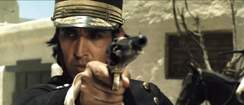Movie still from “The Mexican” (2001), directed by Gore Verbinski – A man wearing a uniform and holding a gun; Close Up shot, Low angle