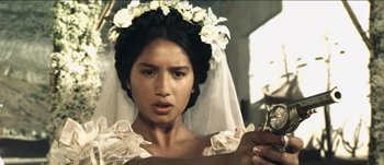 Movie still from “The Mexican” (2001), directed by Gore Verbinski – A woman in a white wedding dress holding a small item; Close Up shot, Overhead angle