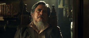 Movie still from “The Mexican” (2001), directed by Gore Verbinski – An older man with long grey hair and a beard; Close Up shot, Low angle