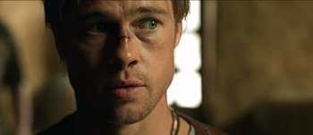 Movie still from “The Mexican” (2001), directed by Gore Verbinski – A man's face with a scar on his face; Close Up shot, Over the shoulder angle