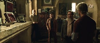 Movie still from “The Mexican” (2001), directed by Gore Verbinski – A group of men standing next to each other in a room; Wide shot, Low angle