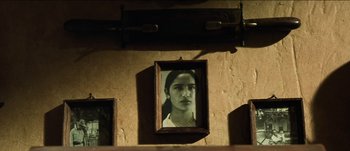 Movie still from “The Mexican” (2001), directed by Gore Verbinski – A picture of a woman hanging on a wall; Extreme Close Up shot, Low angle