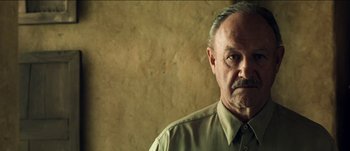 Movie still from “The Mexican” (2001), directed by Gore Verbinski – An older man wearing a shirt and a tie; Close Up shot, Low angle