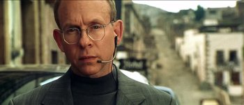 Movie still from “The Mexican” (2001), directed by Gore Verbinski – An older man wearing glasses and a headset; Close Up shot, Low angle