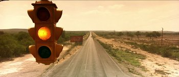 Movie still from “The Mexican” (2001), directed by Gore Verbinski – An image of an empty road going through the desert; Extreme Wide shot, Low angle