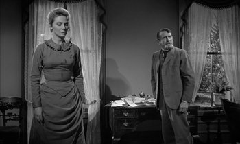 Movie still from “The Miracle Worker” (1962), directed by Arthur Penn – A man and a woman standing next to each other in a room; Medium shot, Low angle