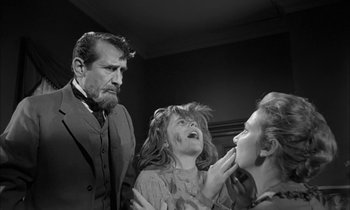 Movie still from “The Miracle Worker” (1962), directed by Arthur Penn – A man and two women in black and white photo; Medium shot, Over the shoulder angle