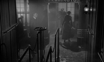 Movie still from “The Miracle Worker” (1962), directed by Arthur Penn – An old photo of people walking in a train station; Wide shot, Low angle