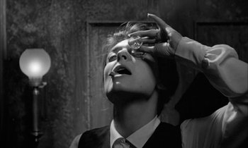 Movie still from “The Miracle Worker” (1962), directed by Arthur Penn – A man in a suit and tie holding a watch; Close Up shot, Low angle