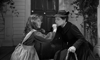Movie still from “The Miracle Worker” (1962), directed by Arthur Penn – An older woman and a young girl in front of a door; Medium shot, Over the shoulder angle