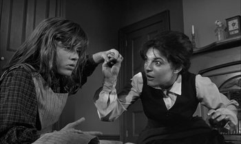 Movie still from “The Miracle Worker” (1962), directed by Arthur Penn – Two women are fighting in a dark room; Medium shot, Low angle