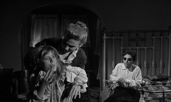 Movie still from “The Miracle Worker” (1962), directed by Arthur Penn – Two women and a little girl in black and white; Medium shot, Over the shoulder angle