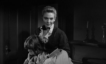 Movie still from “The Miracle Worker” (1962), directed by Arthur Penn – A woman in a black dress and a man in a white shirt; Medium shot, Over the shoulder angle