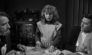Movie still from “The Miracle Worker” (1962), directed by Arthur Penn – A young girl in an apron is making a pie; Medium shot, Over the shoulder angle
