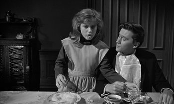 Movie still from “The Miracle Worker” (1962), directed by Arthur Penn – A man and a woman sitting at a dinner table; Medium shot, Over the shoulder angle