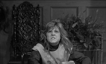 Movie still from “The Miracle Worker” (1962), directed by Arthur Penn – A black and white photo of a woman in a chair; Close Up shot, High angle