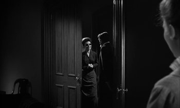 Movie still from “The Miracle Worker” (1962), directed by Arthur Penn – A man and a woman standing next to each other in front of a door; Medium shot, Over the shoulder angle