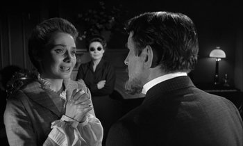 Movie still from “The Miracle Worker” (1962), directed by Arthur Penn – A man and a woman talking to another man in a suit; Medium shot, Over the shoulder angle