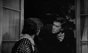 Movie still from “The Miracle Worker” (1962), directed by Arthur Penn – A man and a woman talking to each other outside; Medium shot, Over the shoulder angle