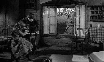 Movie still from “The Miracle Worker” (1962), directed by Arthur Penn – A man and a woman in front of an open window; Wide shot, Over the shoulder angle