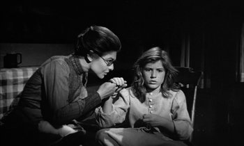 Movie still from “The Miracle Worker” (1962), directed by Arthur Penn – An old photo of a woman and a young girl; Medium shot, High angle