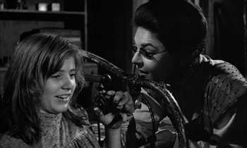Movie still from “The Miracle Worker” (1962), directed by Arthur Penn – A young girl getting her hair cut by a woman; Close Up shot, Over the shoulder angle
