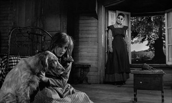 Movie still from “The Miracle Worker” (1962), directed by Arthur Penn – An old photo of a woman and a girl with a dog; Wide shot, Low angle
