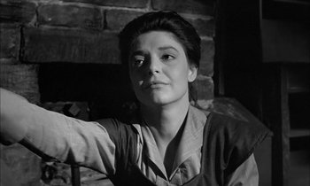 Movie still from “The Miracle Worker” (1962), directed by Arthur Penn – A black - and - white photo of a woman in front of a brick wall; Close Up shot, Low angle
