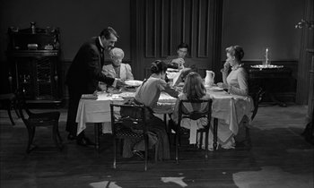 Movie still from “The Miracle Worker” (1962), directed by Arthur Penn – A group of people sitting at a table eating food; Wide shot, High angle