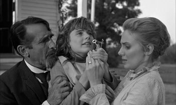 Movie still from “The Miracle Worker” (1962), directed by Arthur Penn – A man and a woman holding a young girl with a pair of shears; Close Up shot, Over the shoulder angle